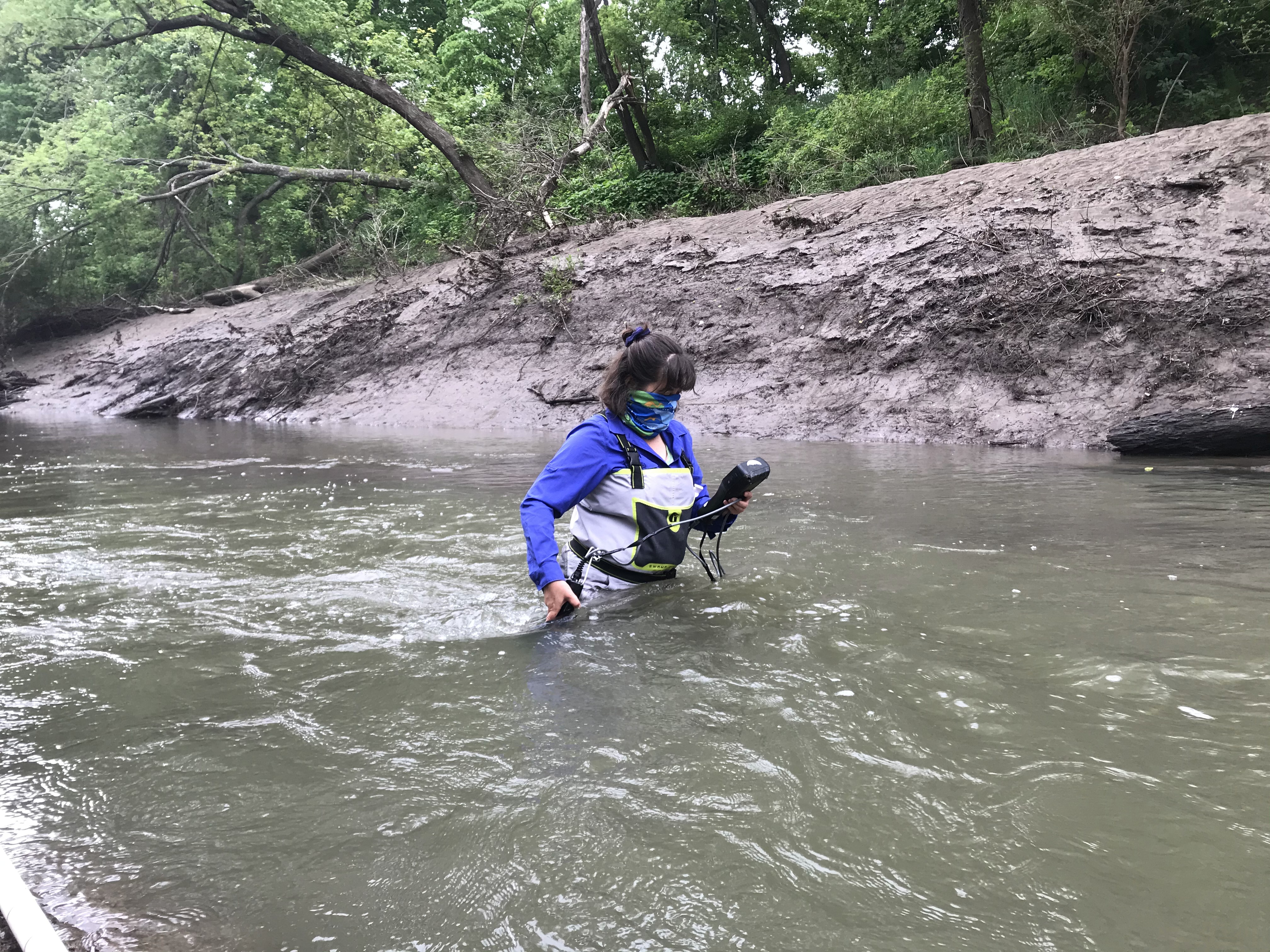 Debbie Baker measuring water chemistry at the upper Wakarusa River site, 20 May 2020.